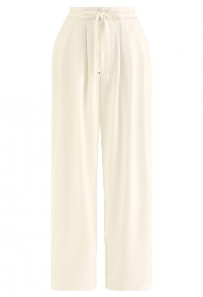 Pantaloni a gamba larga color crema con coulisse in vita con dettagli plissettati