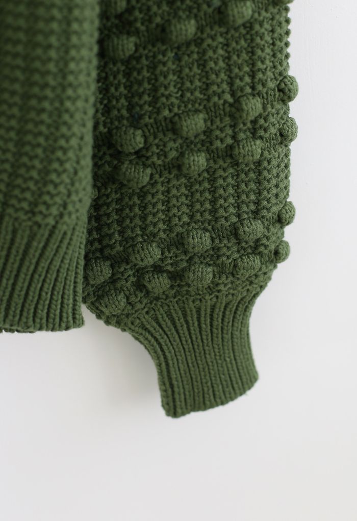 Maglione verde con maniche a bolle e pompon