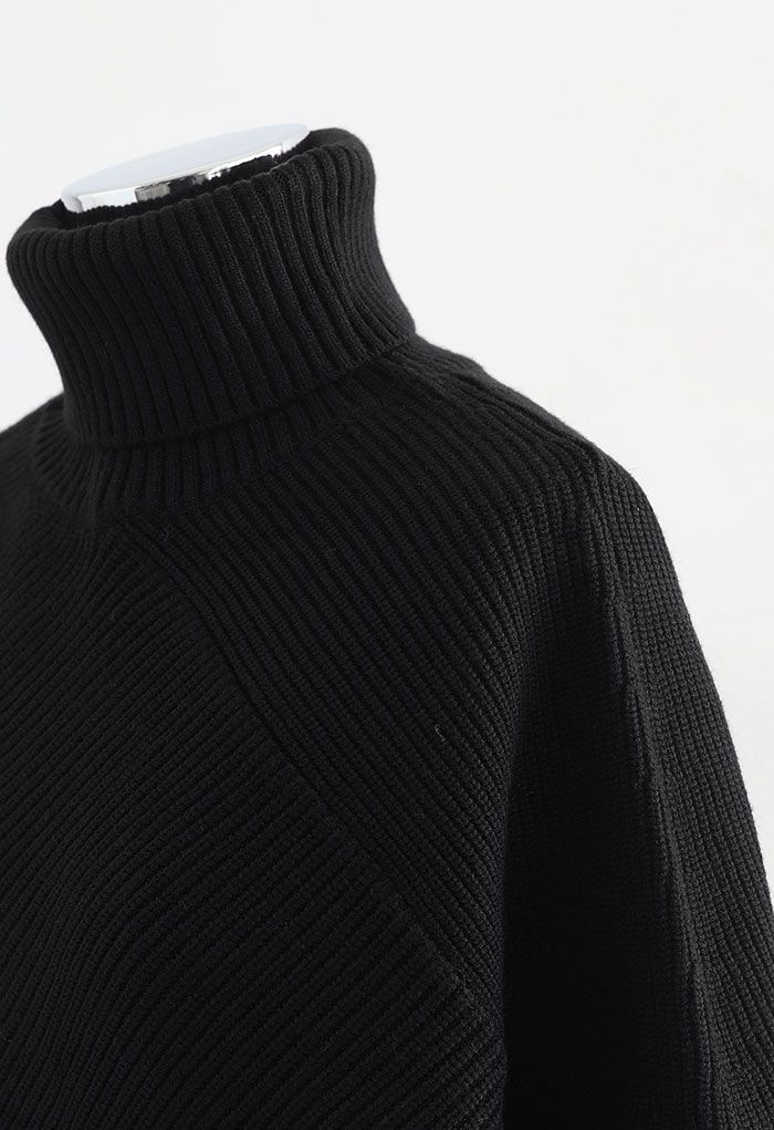 Maglione asimmetrico in maglia con maniche a pipistrello e collo alto in nero