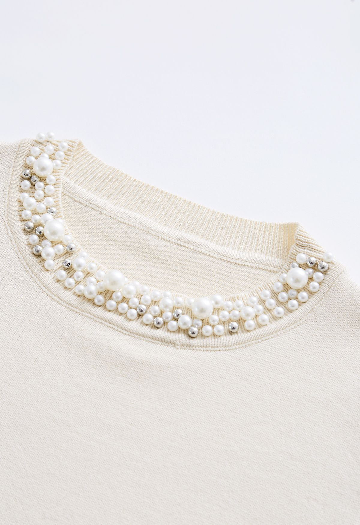 Top in morbida maglia color crema con bordi di perle