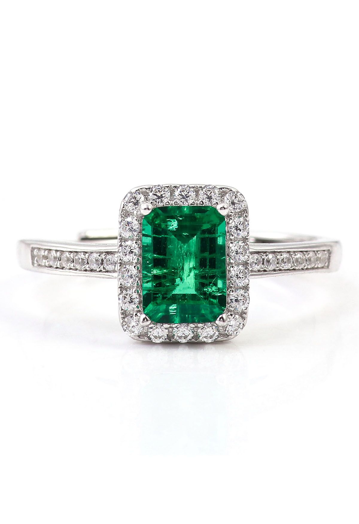 Anello con diamanti incastonati a canale con gemme di smeraldo
