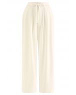 Pantaloni a gamba larga color crema con coulisse in vita con dettagli plissettati